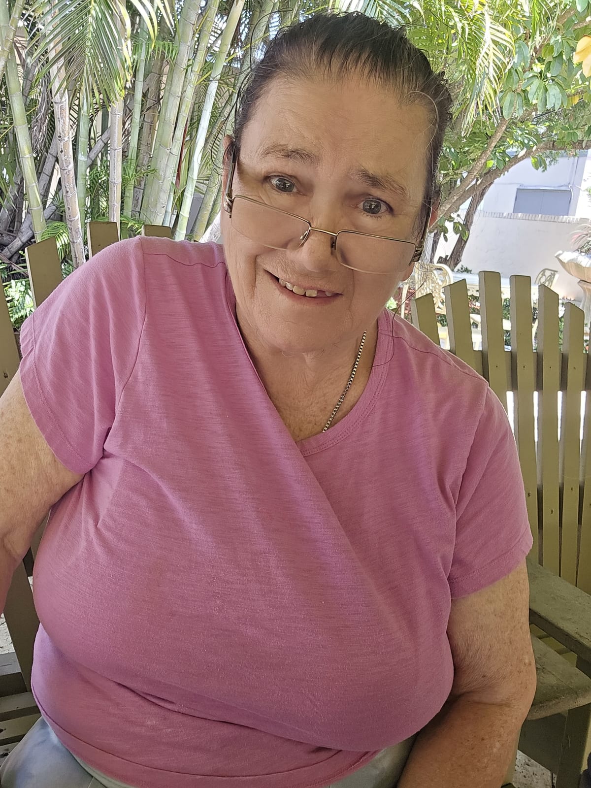 A Royal Palm resident with a vase of flowers in the garden.