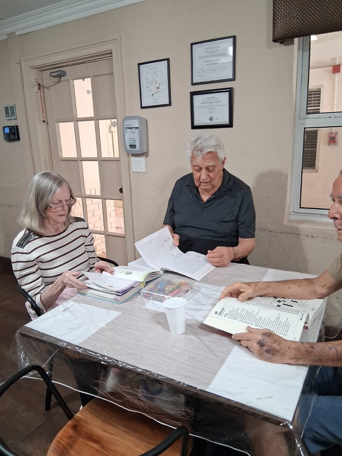 Residents working puzzles together at Royal Palm Senior Residence.