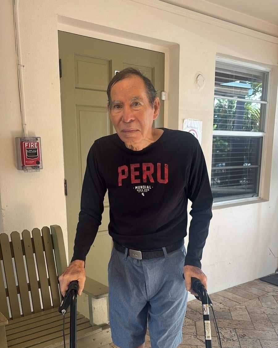A resident in the hallway at Royal Palm Senior Residence during daily life.
