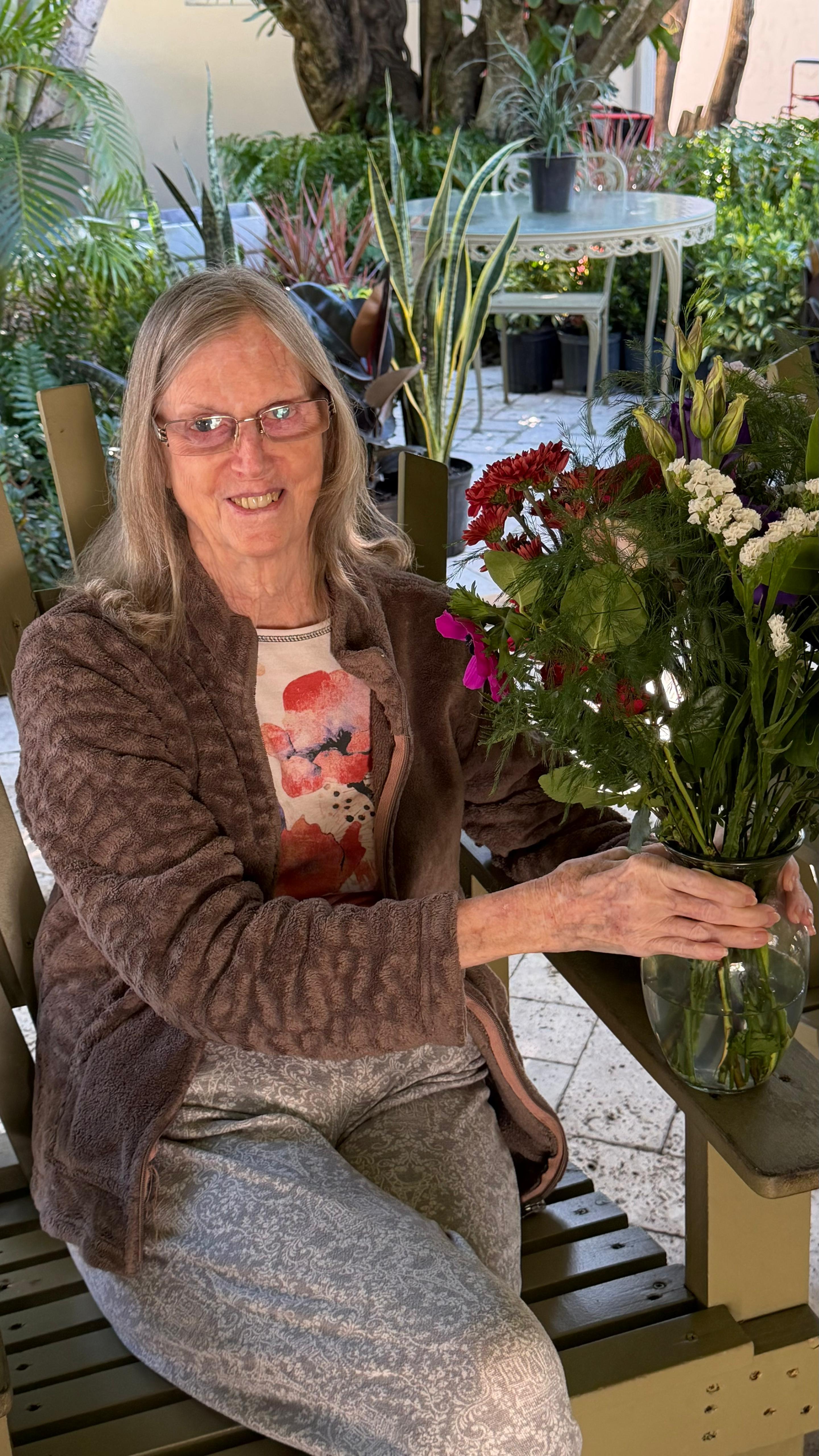 A resident in the garden at Royal Palm Senior Residence in Fort Lauderdale.
