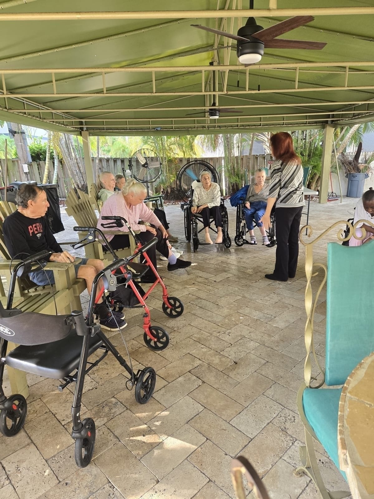 Staff spending time with residents under the patio at Royal Palm Senior Residence.