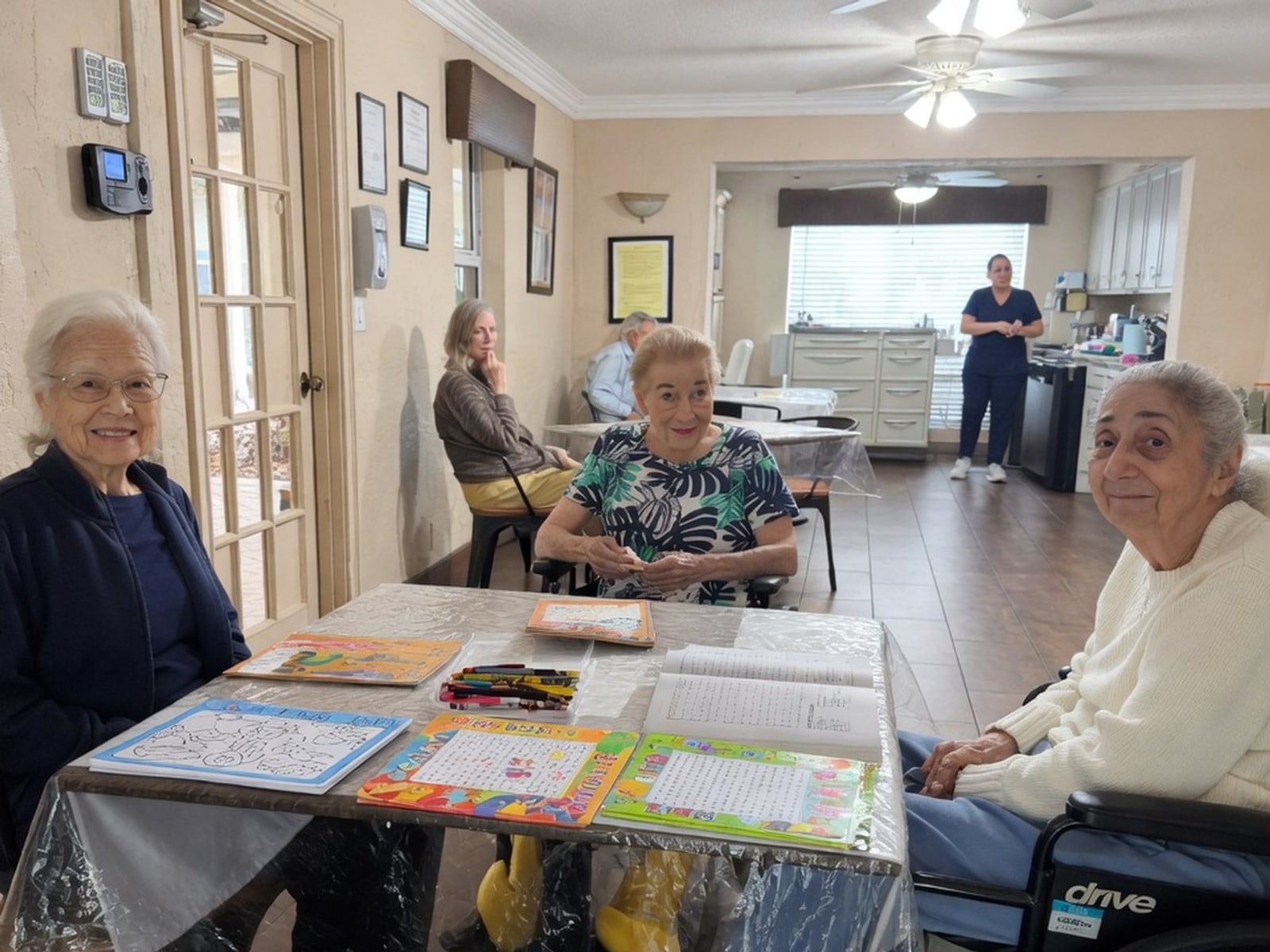 Residents at an activity table in the Royal Palm Senior Residence common room.